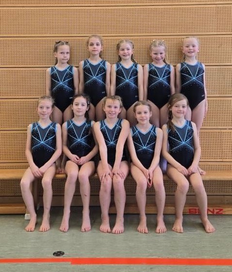 Teen holding child with wood structure